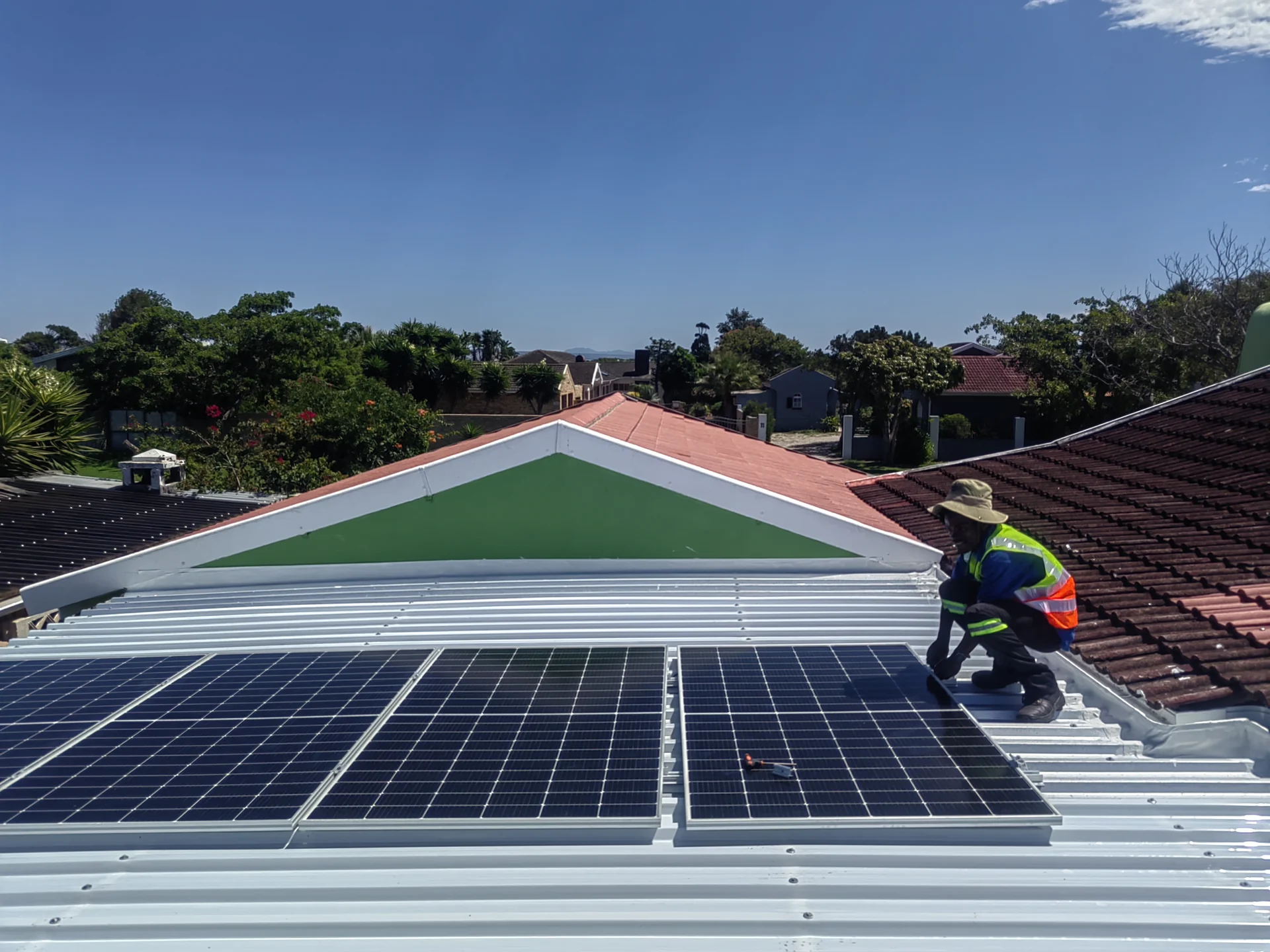 Solar panels installed on a modern residential roof under clear blue sky